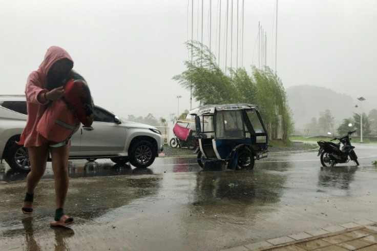 A local tourist arrives to take shelter at a sports complex in Dapa town, Siargao island