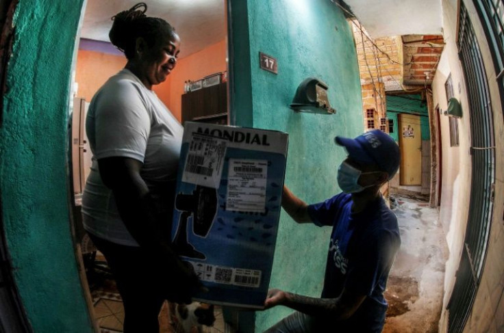 Favela Xpress partners with traditional delivery companies to provide 'last mile' service, gathering parcels at a distribution center at the edge of the favela and bringing them to recipients' doors