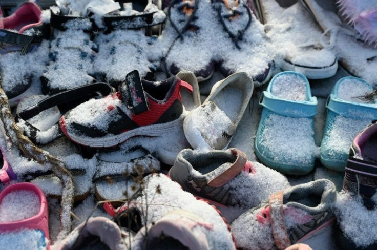 Children's shoes adorn a memorial at the site of the former Saint-Marc-de-Figuery Indigenous residential school -- a way to remember those children lost