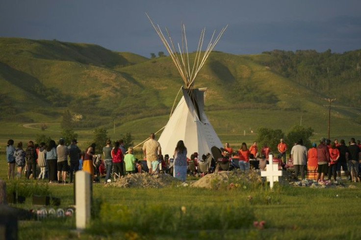 This photo from June 2021 shows hundreds of people gathering for a vigil in a field where human remains were discovered in unmarked graves at the site of the former Marieval Indian Residential School on the Cowessess First Nation in Saskatchewan