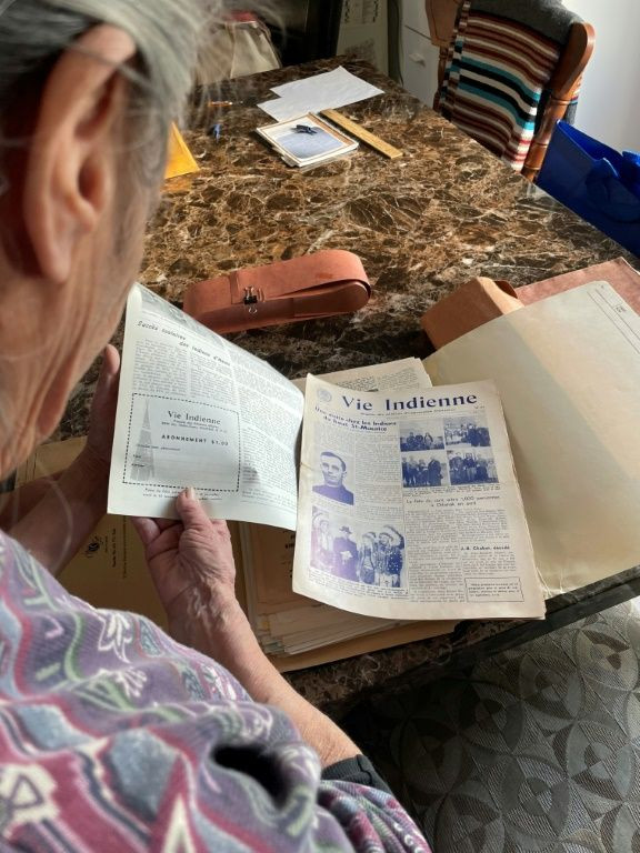 Alice Mowatt shows the notebooks she used to record her memories of her time in a residential school