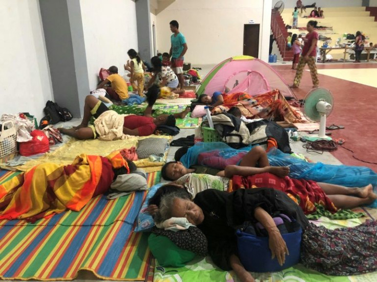 In the town of Dapa, families slept on the floor of a sports complex turned into a temporary evacuation centre