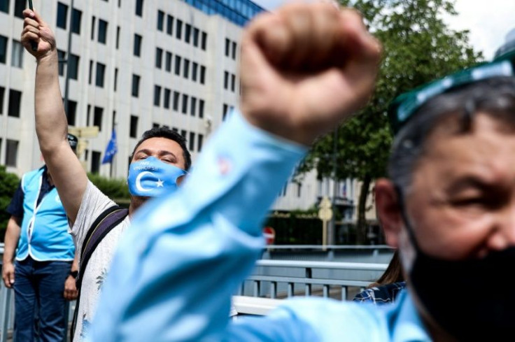 Demonstrators from the Uyghur community take part in a protest near the Belgium parliament in Brussels in July 2021