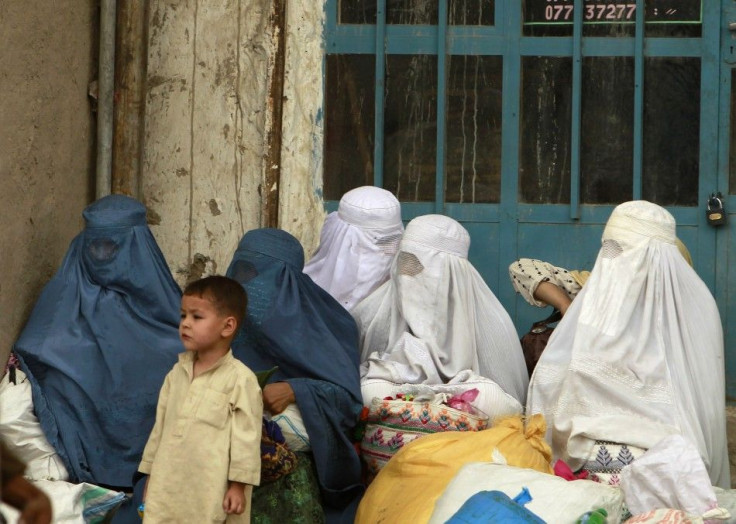 Afghan women wait for transportation in Kabul