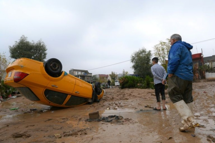 Residents inspect damage in Iraq's Arbil region on December 17, 2021 after flash floods left more than 10 people dead