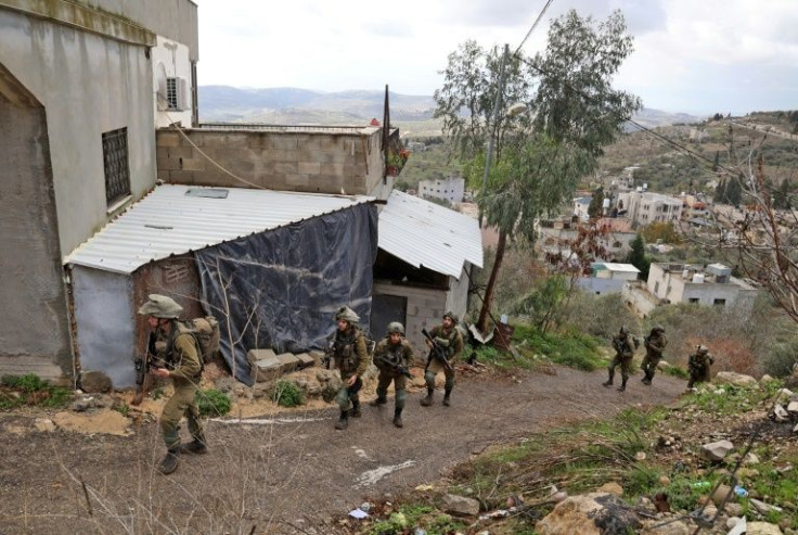 Israeli soldiers patrol the Palestinian village of Burqah, in the occupied West Bank, after reported attacks by settlers