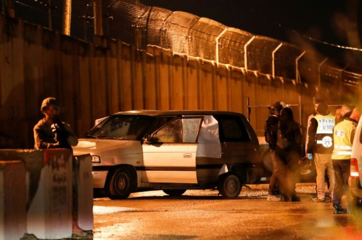 Israeli security forces and forensic experts inspect the car in which three Israelis came under gunfire, killing one, in an attack the army blamed on Palestinian "terrorists" near a settlement in the occupied West Bank