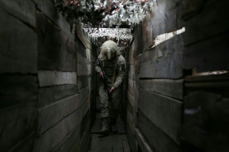 A Ukrainian soldier walks along a trench on the frontline with Russia-backed separatists, not far from town of Avdiivka, Donetsk region, on December 10, 2021.