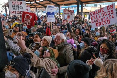 US Senator Bernie Sanders (C) takes selfies with people after speaking to striking  Kellogg's workers in downtown Battle Creek, Michigan, on December 17, 2021