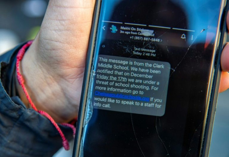 A mother in Massachusetts shows a text from her child's school saying it was aware of social media rumors about a supposed threat of school shootings