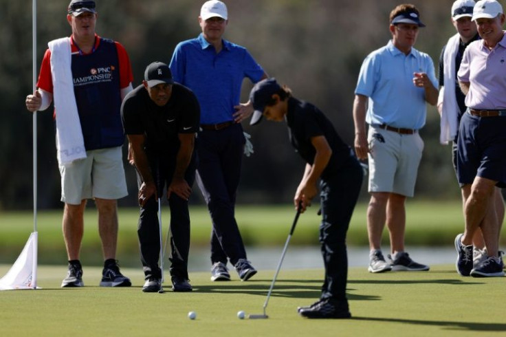 Family affair: Tiger Woods looks on as Charlie Woods putts during the pro-am ahead of the PNC Championship family tournament at the Ritz-Carlton Golf Club in Orlando, Florida