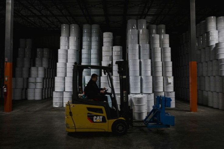 An employee drives past pasteurized maple syrup at the Quebec Maple Syrup Producers storage facility in Laurierville, on December 9, 2021