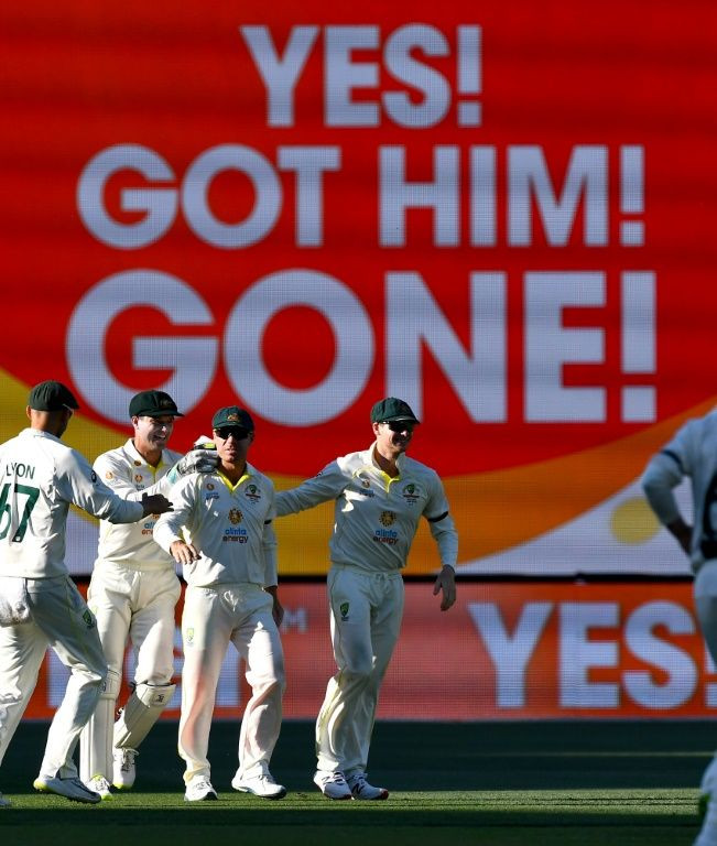 Australia celebrate the wicket of England's Jos Buttler