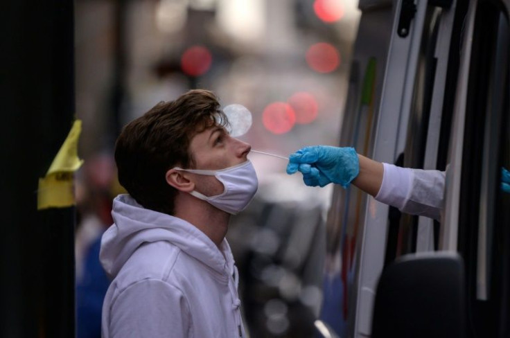 A man undergoes a rapid Covid-19 test at a medical van in New York on December 17, 2021