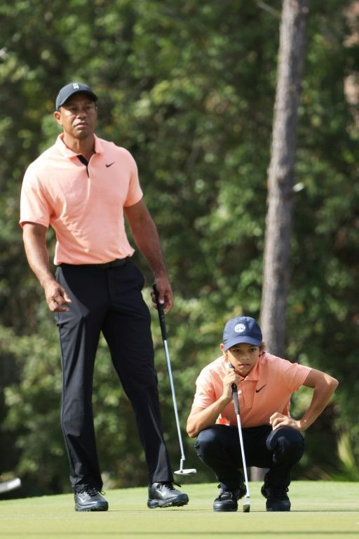 Tiger Woods and Charlie Woods line up a putt at the PNC Championship in Florida on Saturday