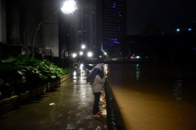 Downpours in Malaysia have caused rivers to overflow, submerging many urban areas and cutting off major roads