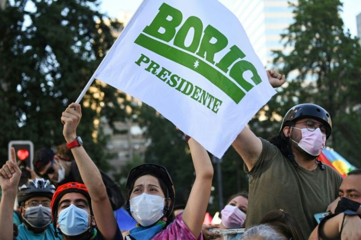 Supporters of Chilean President-elect Gabriel Boric celebrate following the official results of the runoff election, in Santiago on December 19, 2021