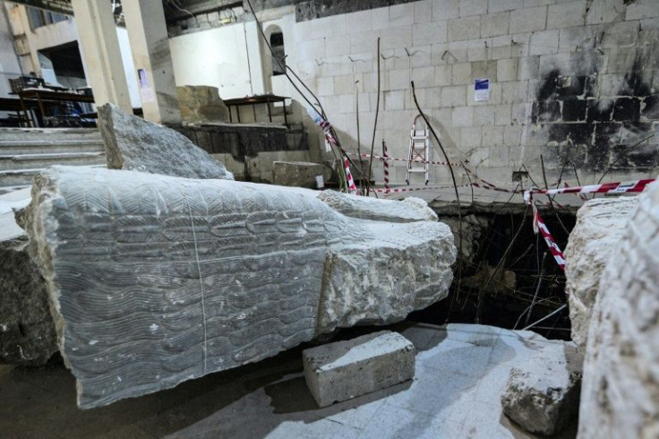 A view of a larger fragment of a statue of a 'lamassu', a human-headed winged bull, is seen being reassembled at the Mosul museum