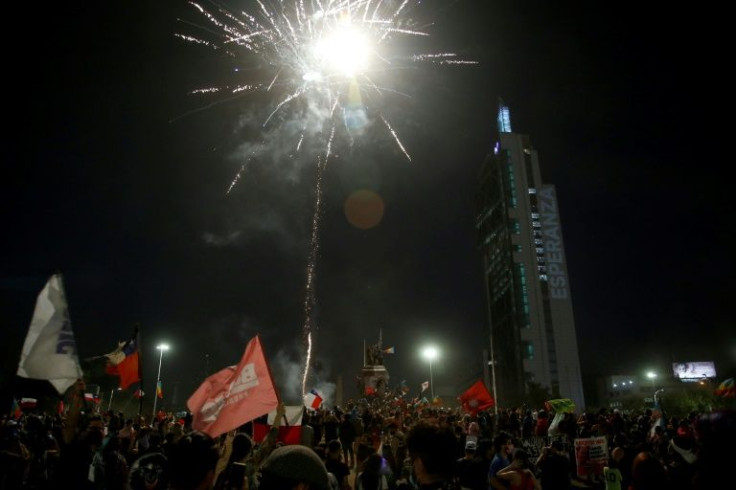 Supporters of Chilean president-elect Gabriel Boric set off fireworks to celebrate the official results of the runoff presidential election, in Santiago, on December 19, 2021
