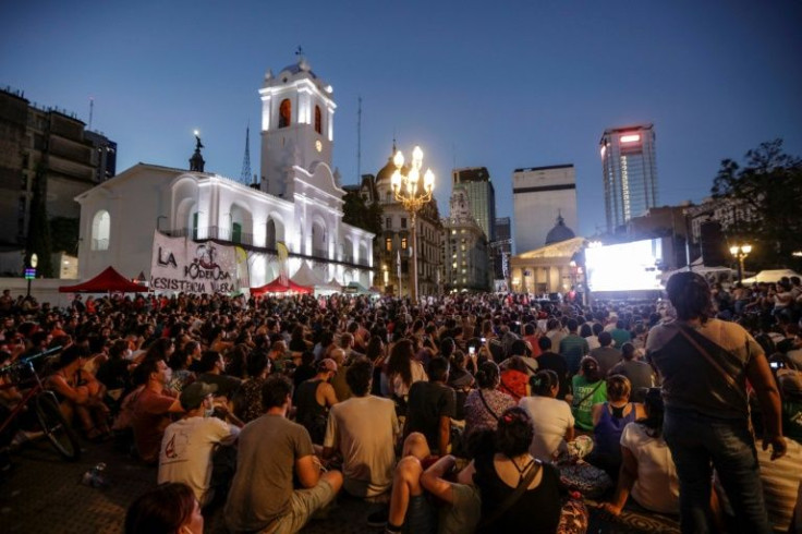 People watch the film 'Diciembre,' as part of the anniversary commemorations of Argentina's 'great crisis' at Plaza de Mayo in Buenos Aires, on December 19, 2021