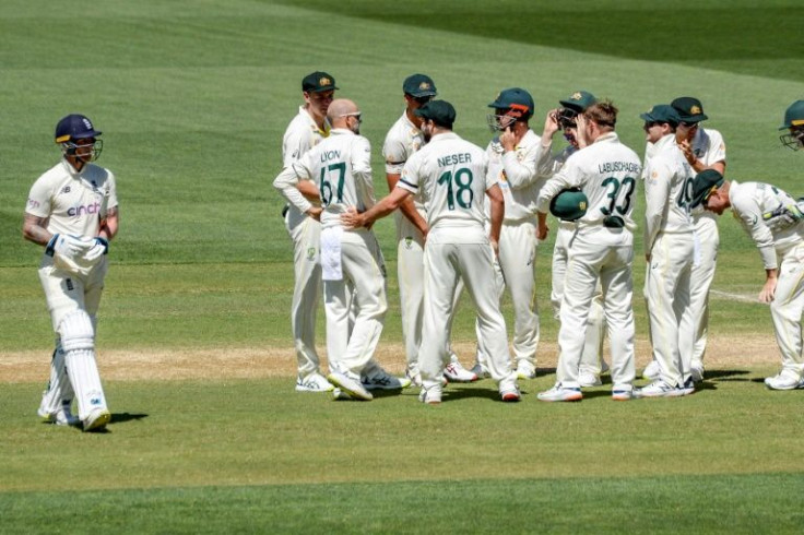 Australia's players celebrate the wicket of Ben Stokes (left)