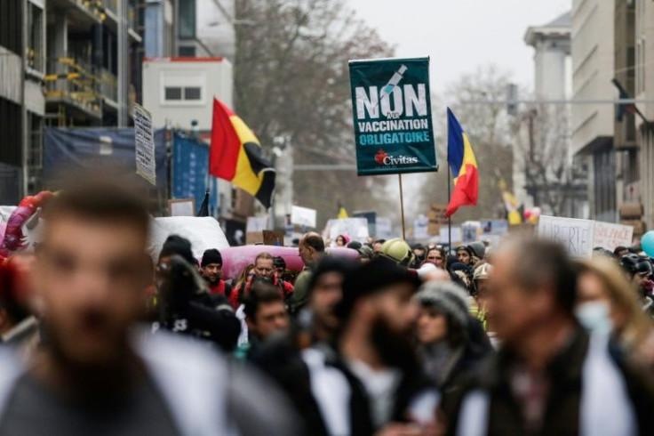 A person holds a sign reading "No to mandatory vaccination" during a demonstration against Covid-19 vaccination in Brussels