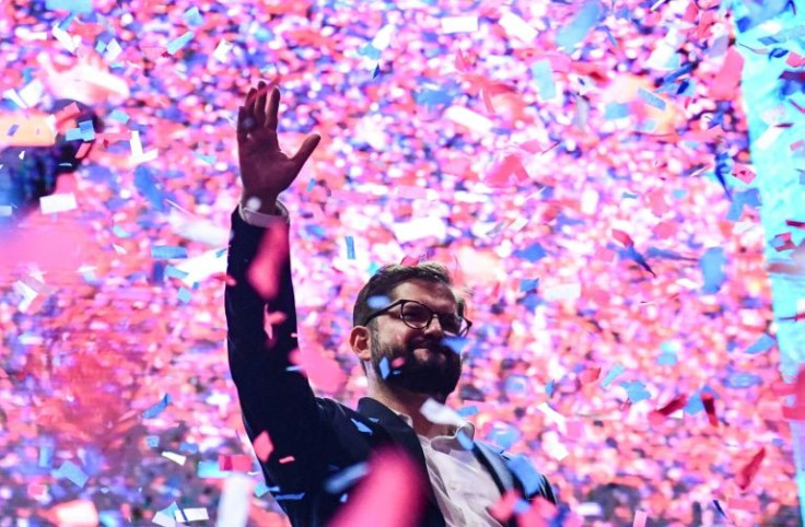 Chilean president-elect Gabriel Boric waves at supporters after delivering his victory speech, in Santiago, on December 19, 2021
