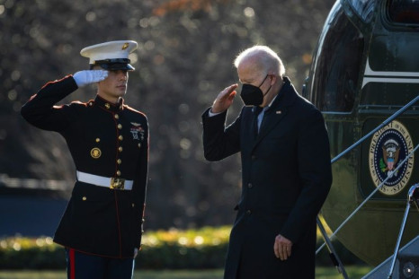 US President Joe Biden salutes as he exits Marine One on the South Lawn of the White House