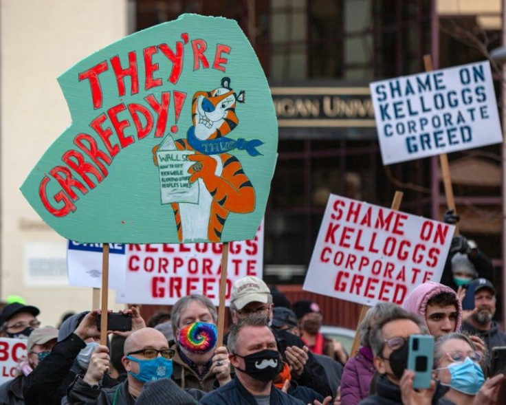 Signs are held during a rally where US Senator Bernie Sanders spoke to striking Kellogg's workers in Battle Creek, Michigan, on December 17, 2021