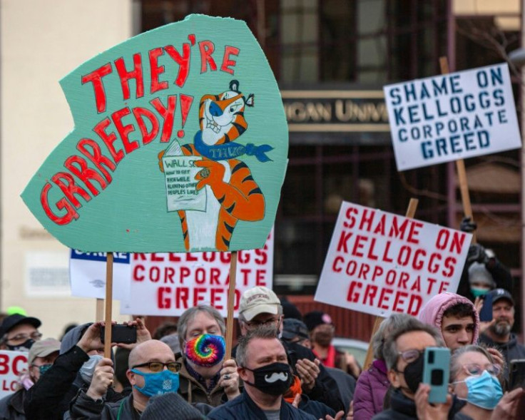 Signs are held during a rally where US Senator Bernie Sanders spoke to striking Kellogg's workers in Battle Creek, Michigan, on December 17, 2021