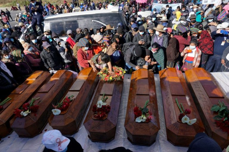 The coffins of seven victims of a massacre in western Guatemala linked to a decades-old land dispute are laid out before their burial