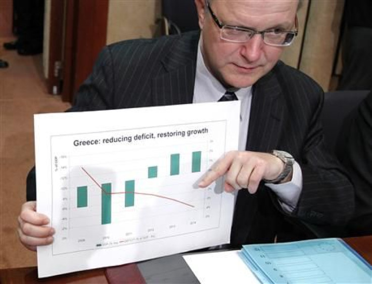 EU Commissioner Rehn displays a graphic during an eurozone finance ministers meeting in Brussels