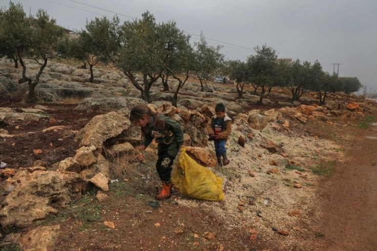 Umm Raghad's children gather scraps of garbage to burn to keep the biting cold at bay