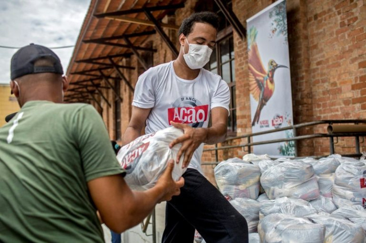 Volunteers load food packages in a van
