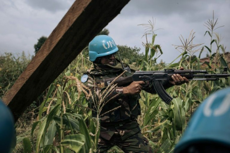 A Bangladeshi soldier with the UN's MONUSCO peacekeeping mission provides covering fire after CODECO militiamen attack a Red Cross party