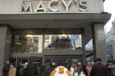 People wait for a Macy's department store to open in New York January 7, 2010. U.S. retailers including Macy's posted higher December sales and raised profit forecasts as they carefully managed promotions to lure shoppers during the holidays.