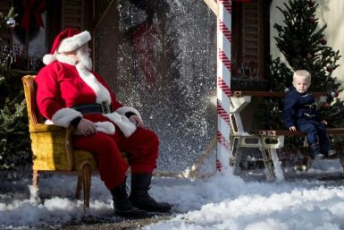 Santa, seen here taking socially-distanced photos with children in Kingston, Canada in November 2020, has been cleared for travel in Canada's airspace this Christmas after showing proof of vaccination