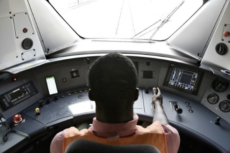 Let the train take the strain: Driver Momar Diop Sidibe in one of Dakar's brand-new commuter locomotives