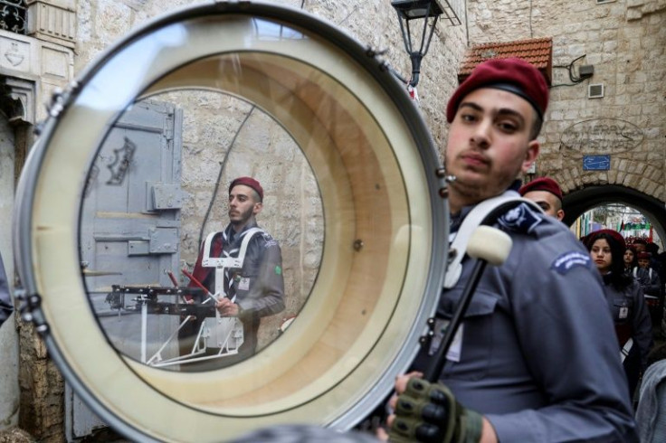 Members of a scout band parade outside the Church of the Nativity in Bethlehem on December 24, 2021