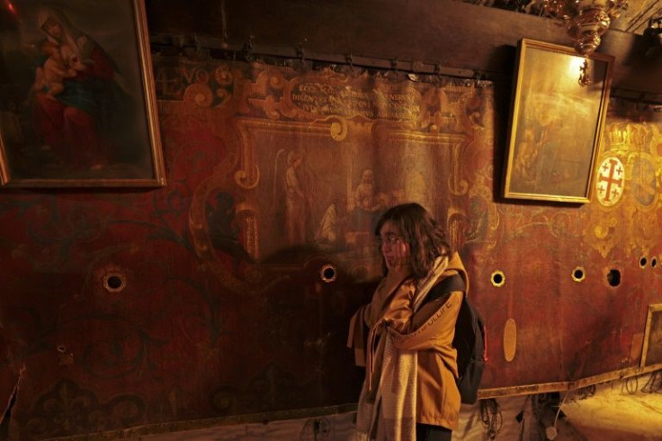 A pilgrim visits the Church of the Nativity in Bethlehem on December 24, 2021
