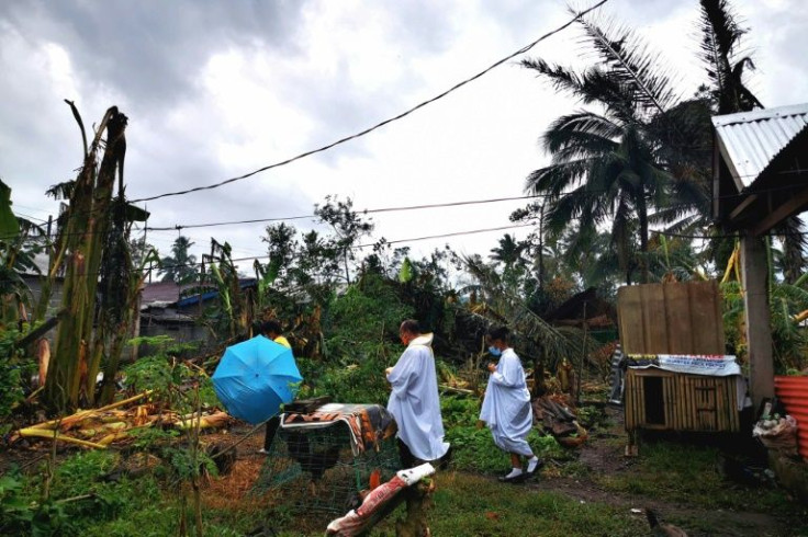 Father Ricardo Virtudazo walks among downed banana trees felled by Super Typhoon Rai