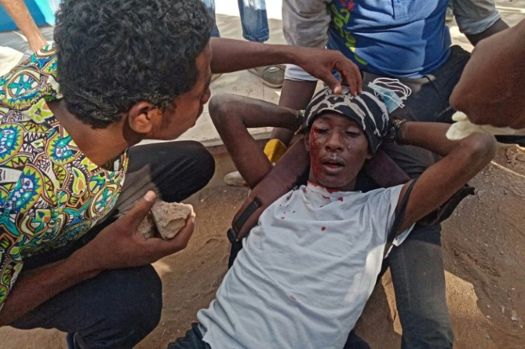 A Sudanese protester receives first aid on December 19, with more demonstrations slated for Saturday
