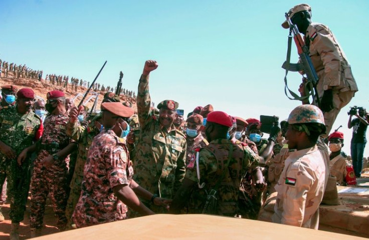 Sudan's top general Abdel Fattah al-Burhan greets soldiers on December 8