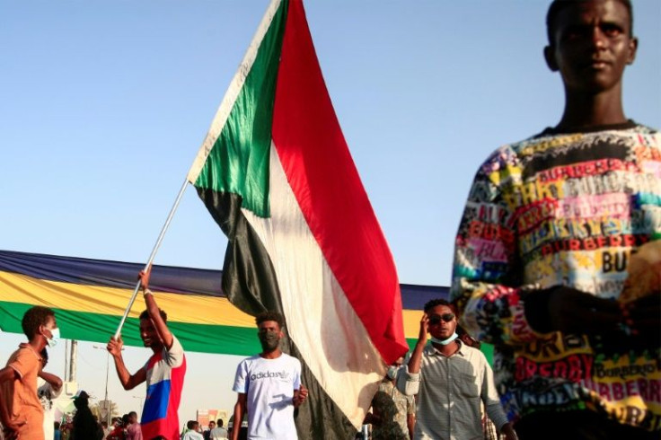 A demonstrator waves the Sudanese national flag during a protest on December 13, 2021