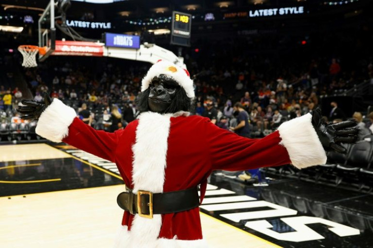 The Phoenix mascot 'The Gorilla,' dressed as Santa Claus, exhorts fans before the Suns' NBA game against the Golden State Warriors