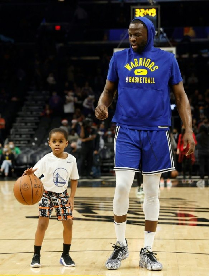 Golden State's Draymond Green warms up alongside son, Draymond Green Jr., before the Warriors' Christmas NBA game against the Suns in Phoenix
