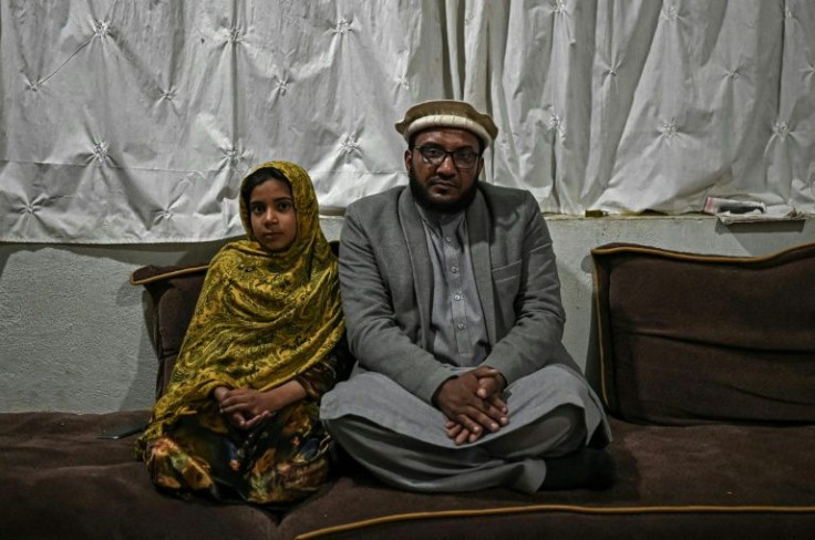 Businessman Ehsanullah Maroof (R) can't afford the right medicine for an epileptic son, and daughter Rana has been expelled because the family can't pay school fees