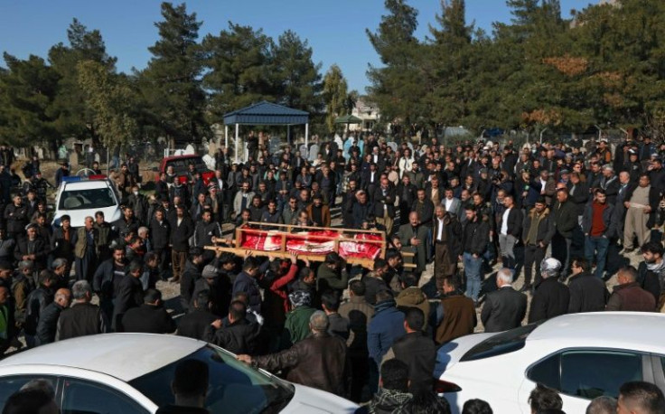 Relatives of the 16 Kurds, killed when their boat sank in the Channel while trying to reach England, attend their funeral in Raniya, east of Arbil, the capital of Iraq's autonomous Kurdish region