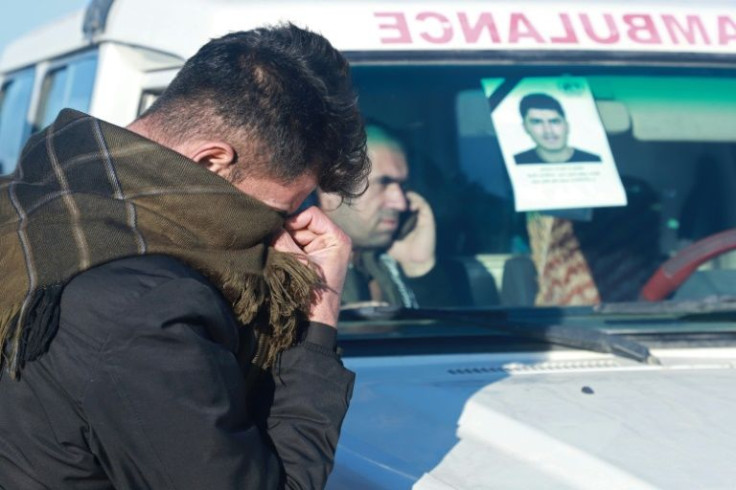 A relative of one of the 16 Kurds, killed when their boat sank in the Channel while trying to reach England, attends their funeral in Raniya, east of Arbil, the capital of Iraq's northern autonomous Kurdish region
