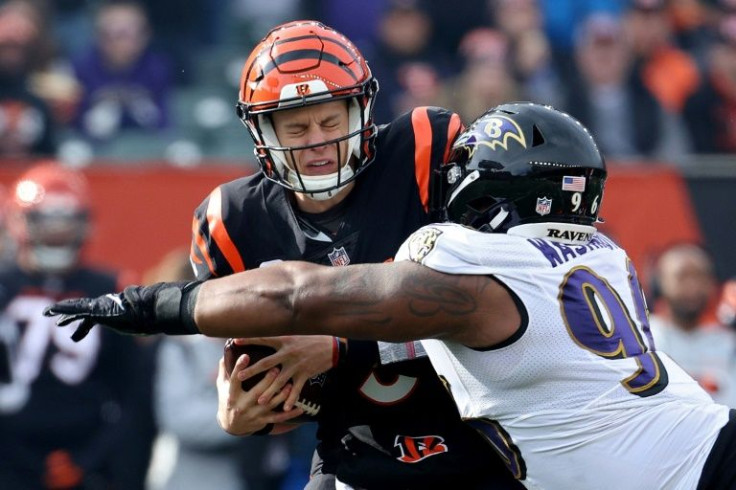 Cincinnati quarterback Joe Burrow avoids a sack from Baltimore's Broderick Washington in the Bengals' NFL victory over the Ravens